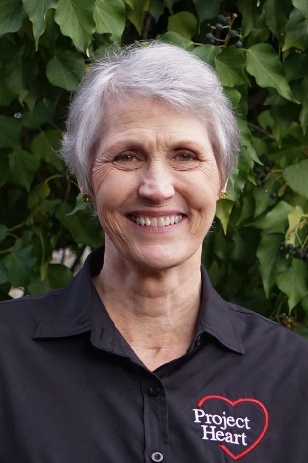 Carol Viola Staff Photo wearing a black Project Heart button up shirt