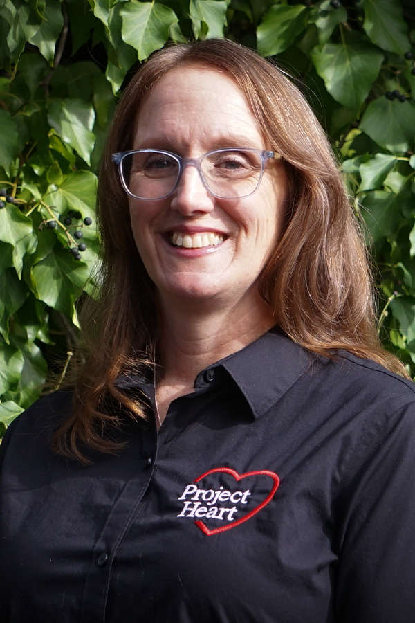 Christy Thompson Staff Photo wearing a black Project Heart button up shirt