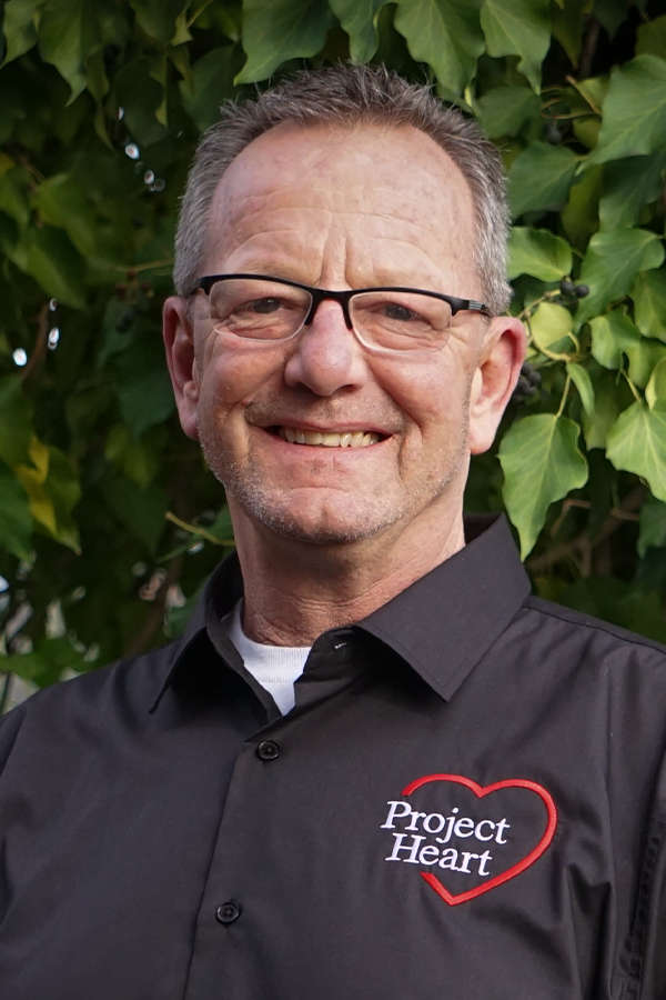 Dave Mullan Staff Photo wearing a black Project Heart button up shirt