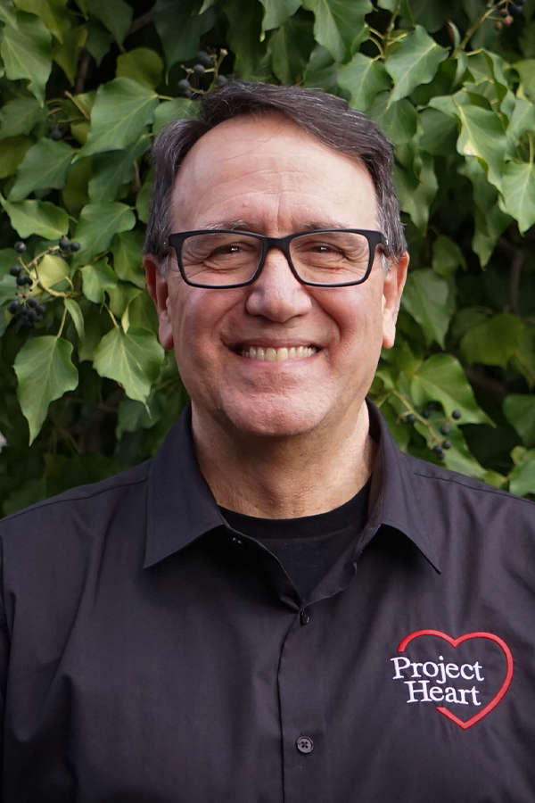 Fred Viola Staff Photo wearing a black Project Heart button up shirt