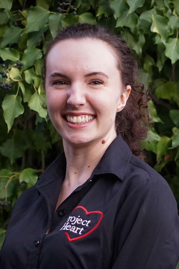 Olivia Donley Staff Photo wearing a black Project Heart button up shirt