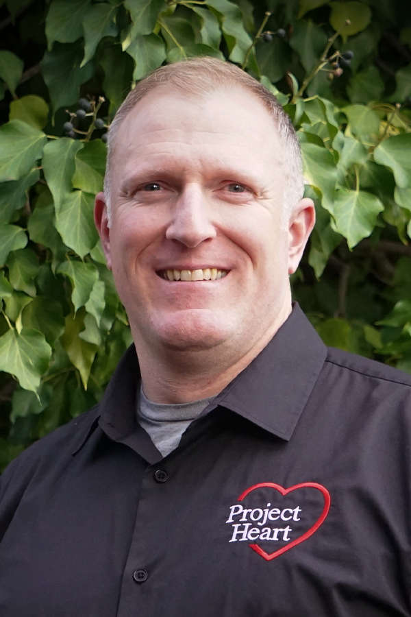 Ryan Nestell Staff Photo wearing a black Project Heart button up shirt